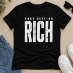 busy-getting-rich-tshirt-black-flatlay Black Busy Getting Rich tee flat lay - bold distressed print pressed in Toronto