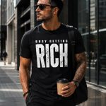 busy-getting-rich-tshirt-man-black-street Man wearing black Busy Getting Rich tee on the street - entrepreneur tee Toronto