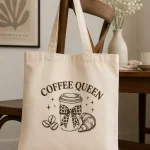 coffee-queen-tote-bag-cafe-chair Coffee Queen canvas tote with leopard bow coffee cup design on a cafe chair - PrintMyVibe Toronto