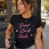 Woman wearing black Good Luck Babe fitted tee with pink script - PrintMyVibe Toronto