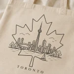 toronto-maple-leaf-tote-bag-mockup-08 Toronto skyline leaf tote flat lay - reusable souvenir bag by PrintMyVibe