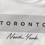 Toronto North York print close-up - houndstooth block and script detail