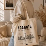 toronto-summer-2026-tote-bag-mockup-05 Toronto skyline tote - reusable souvenir bag by PrintMyVibe
