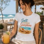 salt-sand-and-sunshine-top-model-drink Woman in the Salt Sand & Sunshine beach tee at a seaside bar with a cold drink