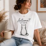 Autumn Not For Me cat t-shirt worn on a sofa with a mug and candle - cosy cat lover tee