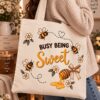 Woman holding the Busy Being Sweet canvas tote - bee and honey dipper design - PrintMyVibe Toronto