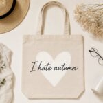 I Hate Autumn canvas tote flat lay with a straw hat and glasses - funny autumn tote
