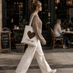 Woman walking past a cafe with the I Hate Coffee tote - funny coffee lover tote GTA
