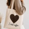Woman carrying the I Hate Coffee canvas tote - coffee bean heart design - PrintMyVibe Toronto