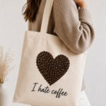 Woman carrying the I Hate Coffee canvas tote - coffee bean heart design - PrintMyVibe Toronto