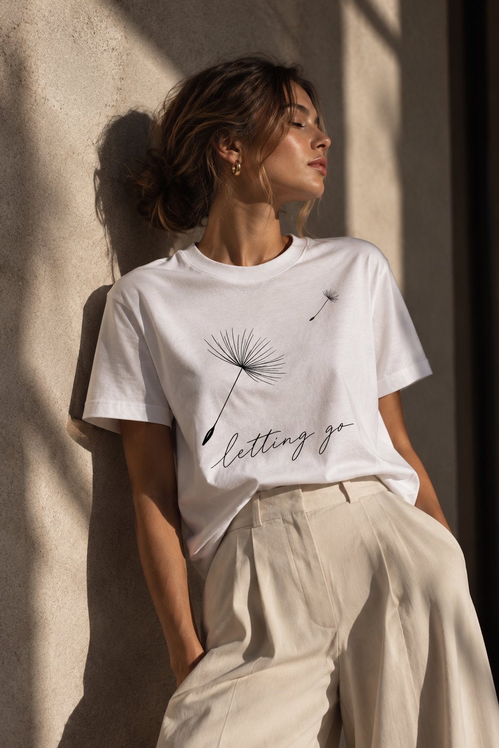 Letting Go dandelion t-shirt worn seated in warm sunlight - calm minimalist tee Toronto
