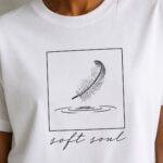 Soft Soul print close-up - framed feather touching water with script lettering
