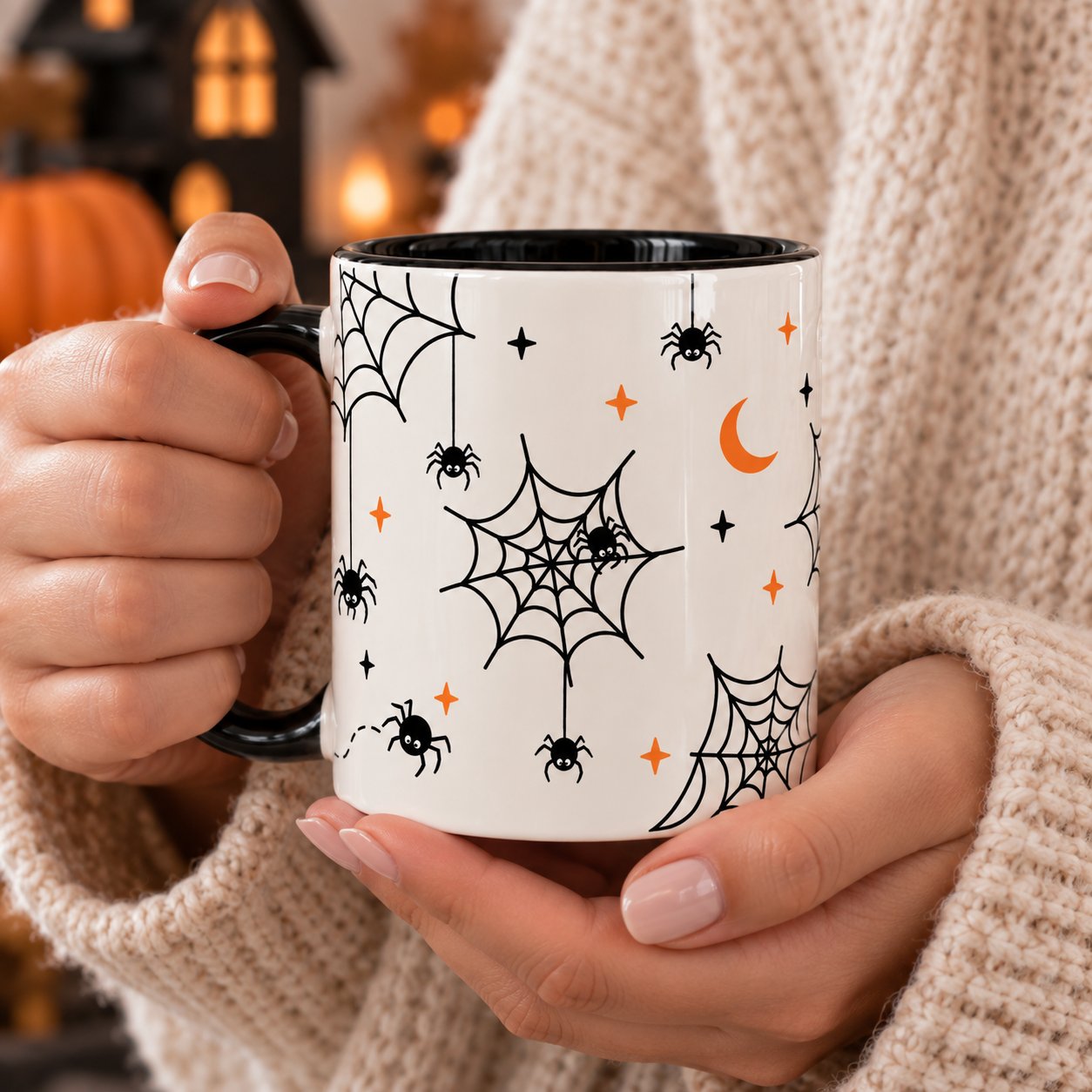 Hands holding the Spiderweb ceramic mug in a cream knit sweater - Halloween mug Toronto
