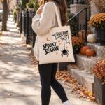 Woman carrying the Spooky Season tote on an autumn street - Halloween tote bag GTA