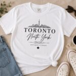 Toronto North York white t-shirt flat lay with jeans, sunglasses and sneakers - Toronto skyline tee