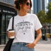 Woman wearing the Toronto North York white t-shirt outside North York Centre - the 6ix skyline tee - PrintMyVibe Toronto