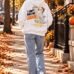 Back of the I Can't Hold My Liquor hoodie walking down a leaf-covered path - back print ghost hoodie