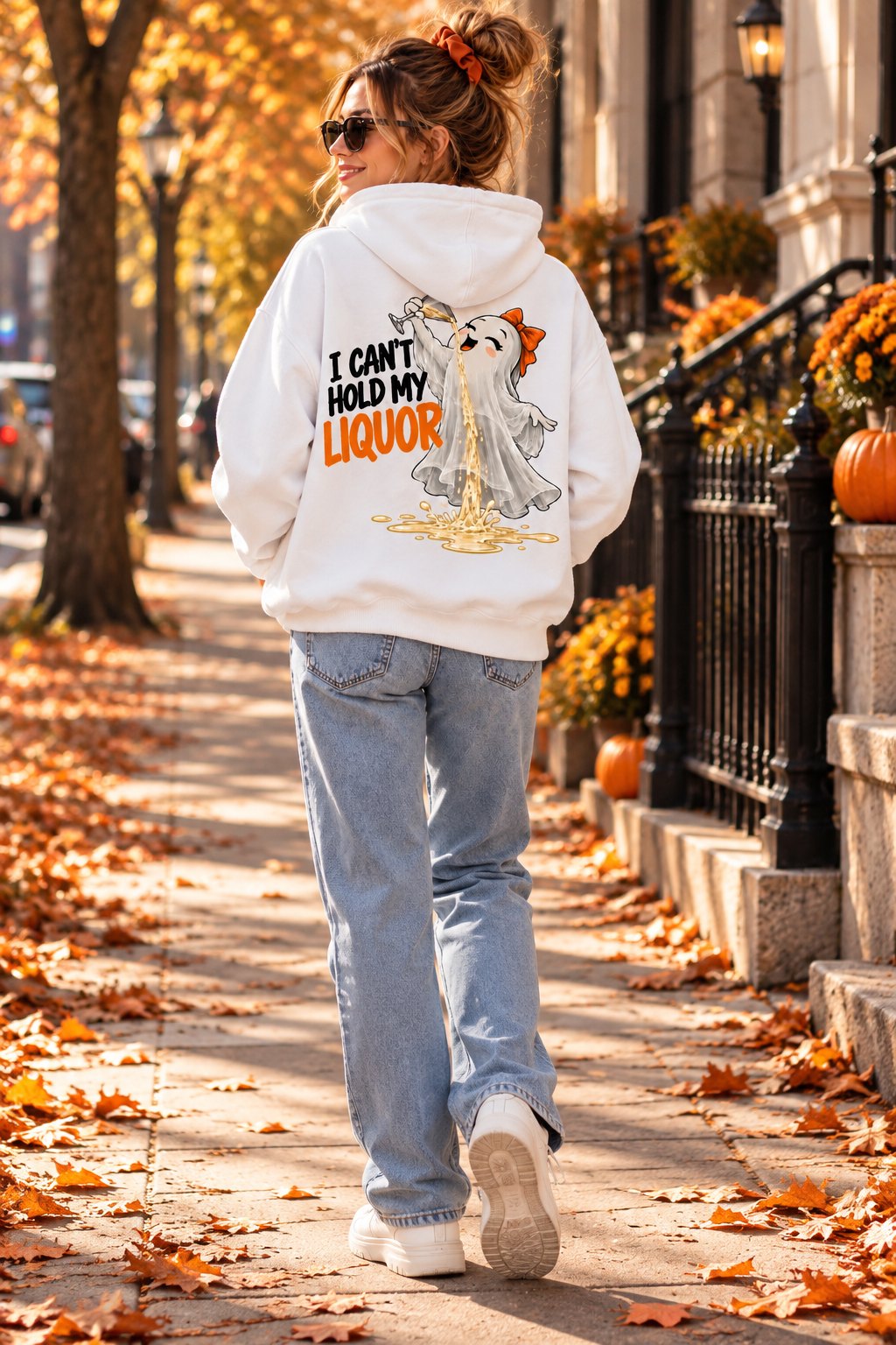 Back of the I Can't Hold My Liquor hoodie walking down a leaf-covered path - back print ghost hoodie