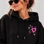 Close-up of the small chest print - dripping pink heart with stars on black fleece